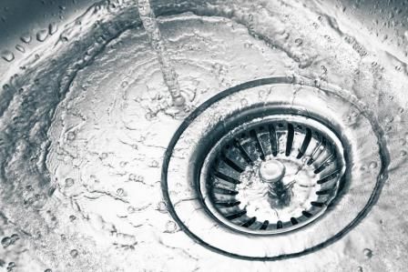 Water running down a clean kitchen sink in Vancouver
