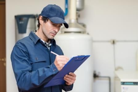 Richmond heating contractor checking off an inspection list